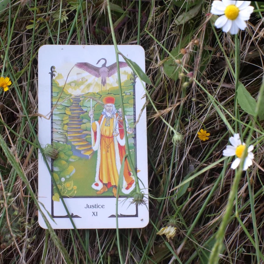 The Justice tarot card photographed outdoors