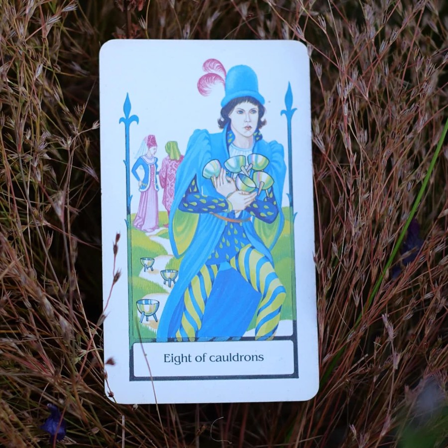 The Eight of Cups tarot card photographed outdoors