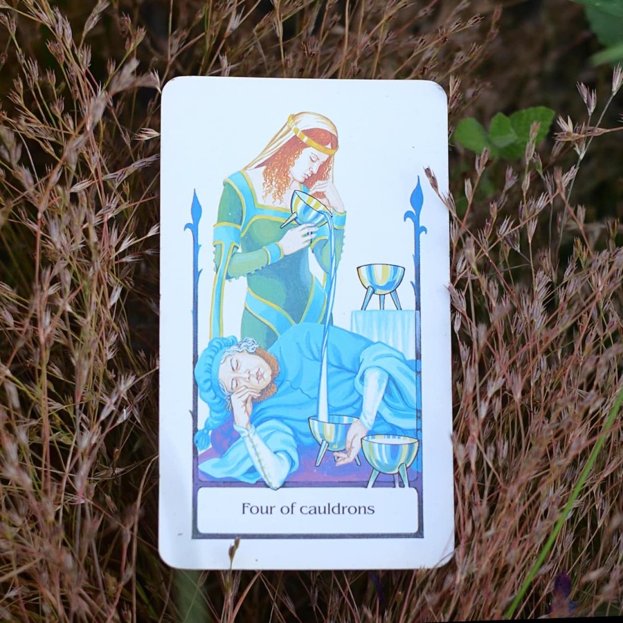 The Four of Cups tarot card photographed outdoors