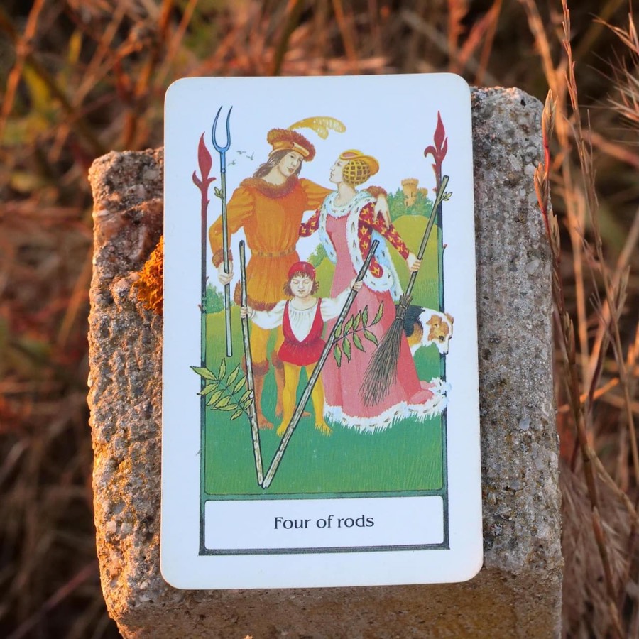 The Four of Wands tarot card photographed outdoors