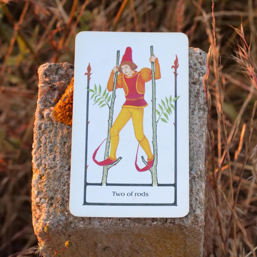 The Two of Wands tarot card photographed outdoors