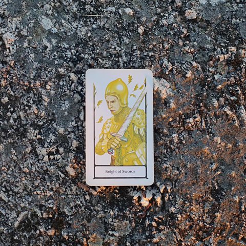 Knight of Swords tarot card, photographed outdoors